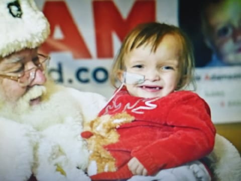 Children from the Cardiff cancer unit receive Christmas gifts from Santa