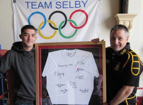 Barry Olympic Boxer presents signed team shirt